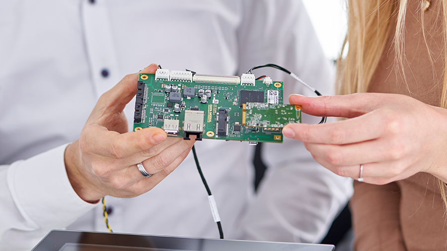 man and woman holding an embedded board