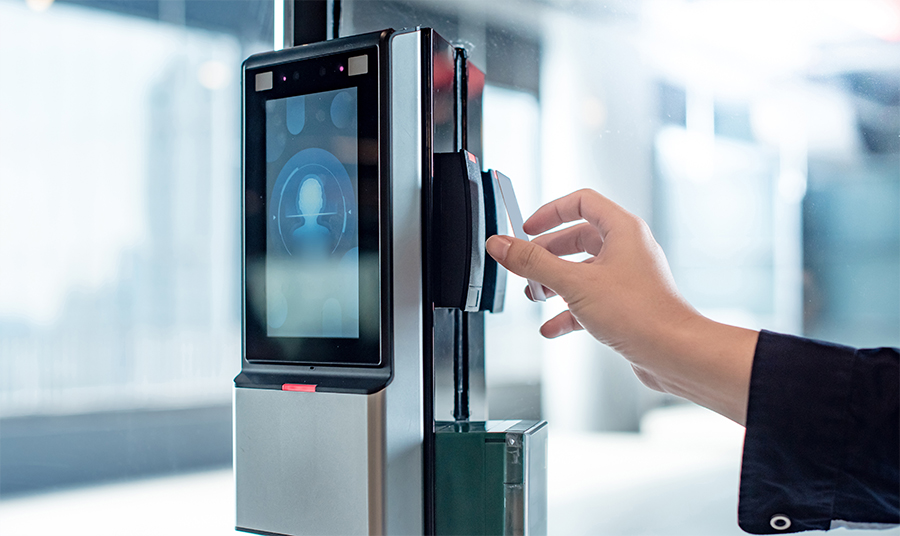 Hand holding an ID card at access point