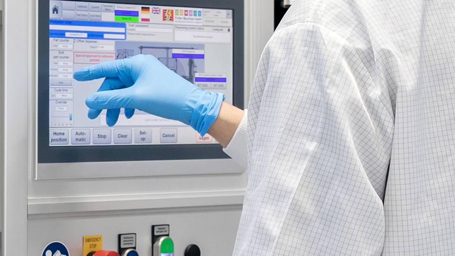 man touching an industrial hmi with gloves