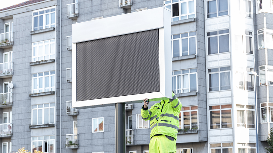 worker reparing a large screen outdoor